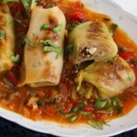 stuffed vegetarian cabbage in sauce on a platter