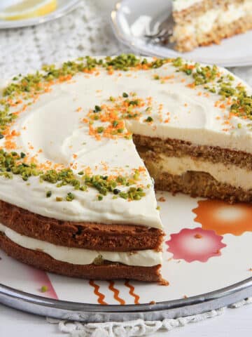 carrot almond cake with orange cream filling on a vintage platter.