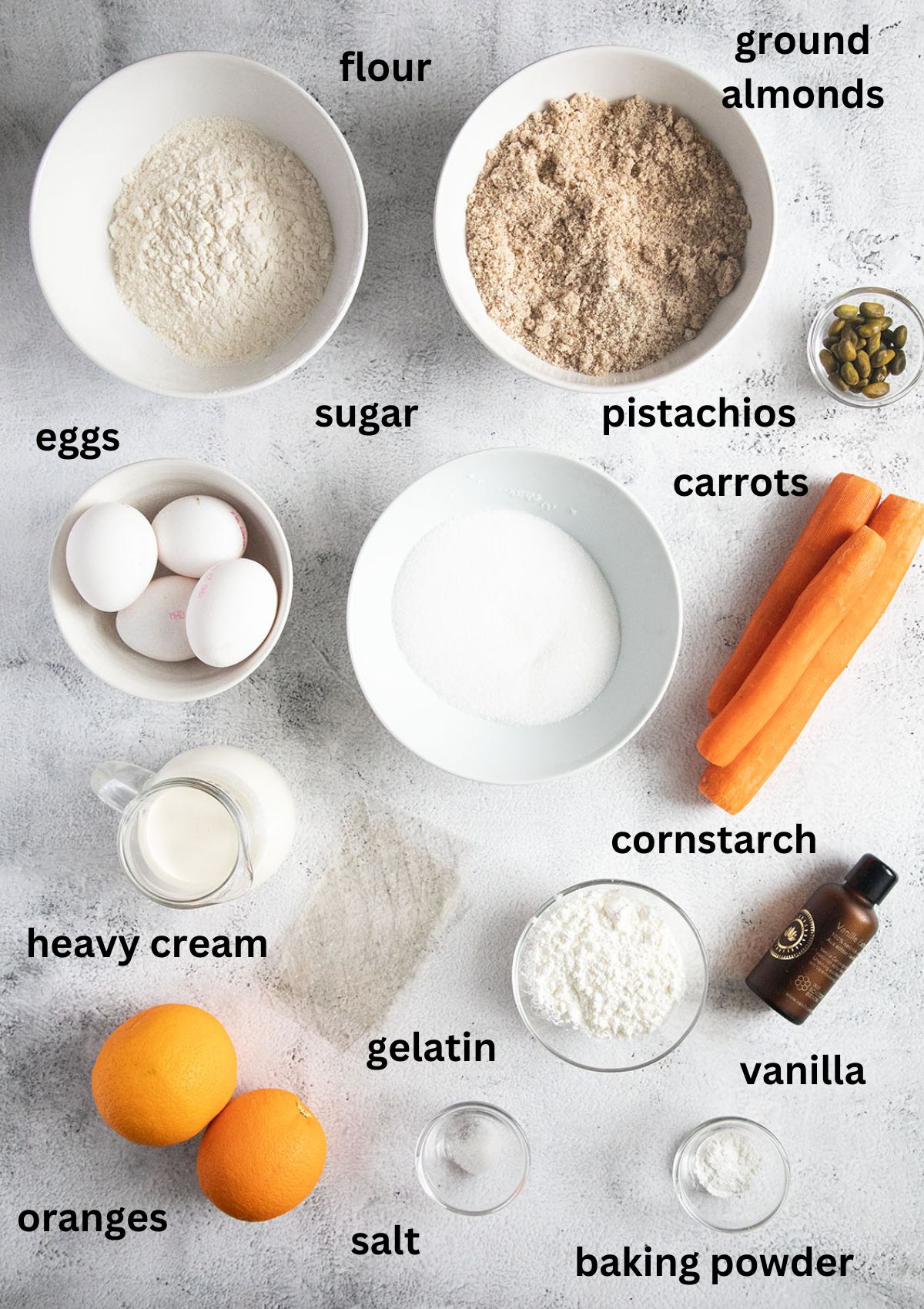labeled ingredients for making almond carrot cake with orange and heavy cream filling.