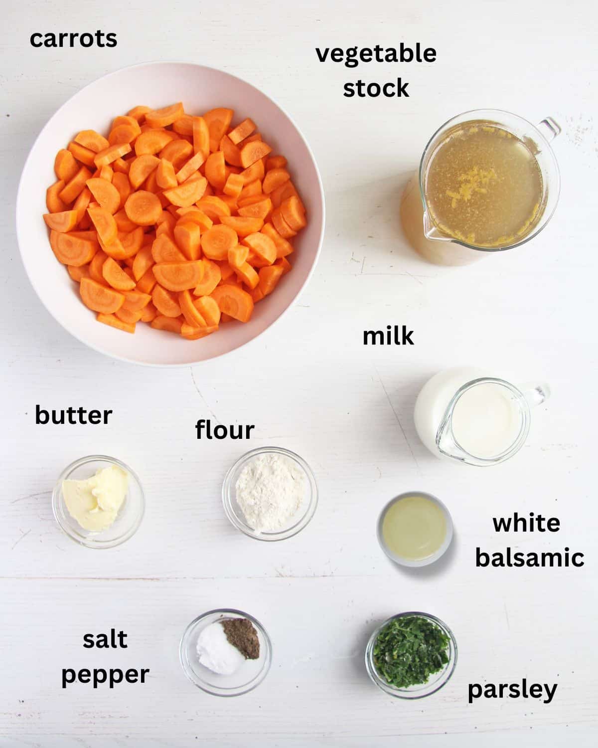 labeled ingredients for making carrot soup with milk and roux.