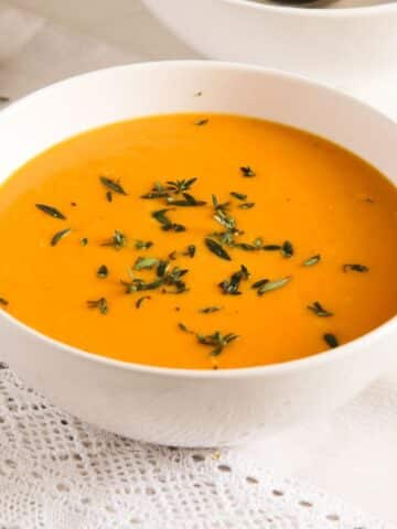 cream of carrot soup with milk in a bowl.