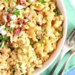 macaroni salad with bacon and eggs in a bowl