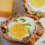 fried scotch eggs and cheddar on a platter