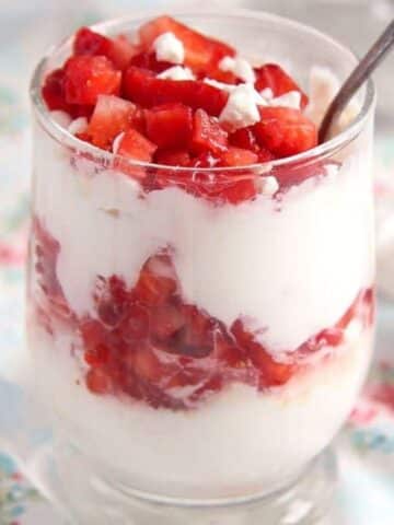 meringue strawberry cream dessert layered in a glass.