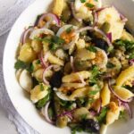 romanian oriental potato salad with olives in a large bowl