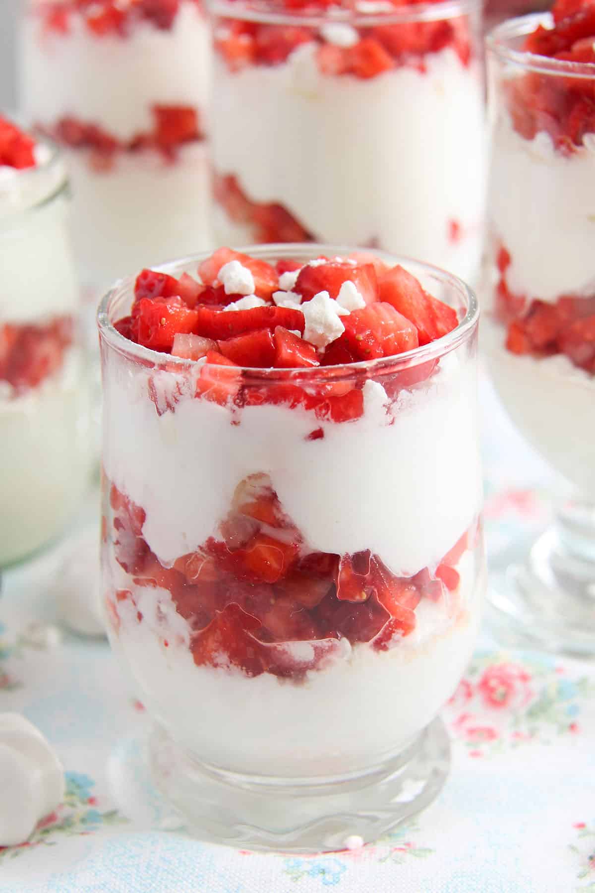 glasses full with strawberries layered with cream cheese and meringue.