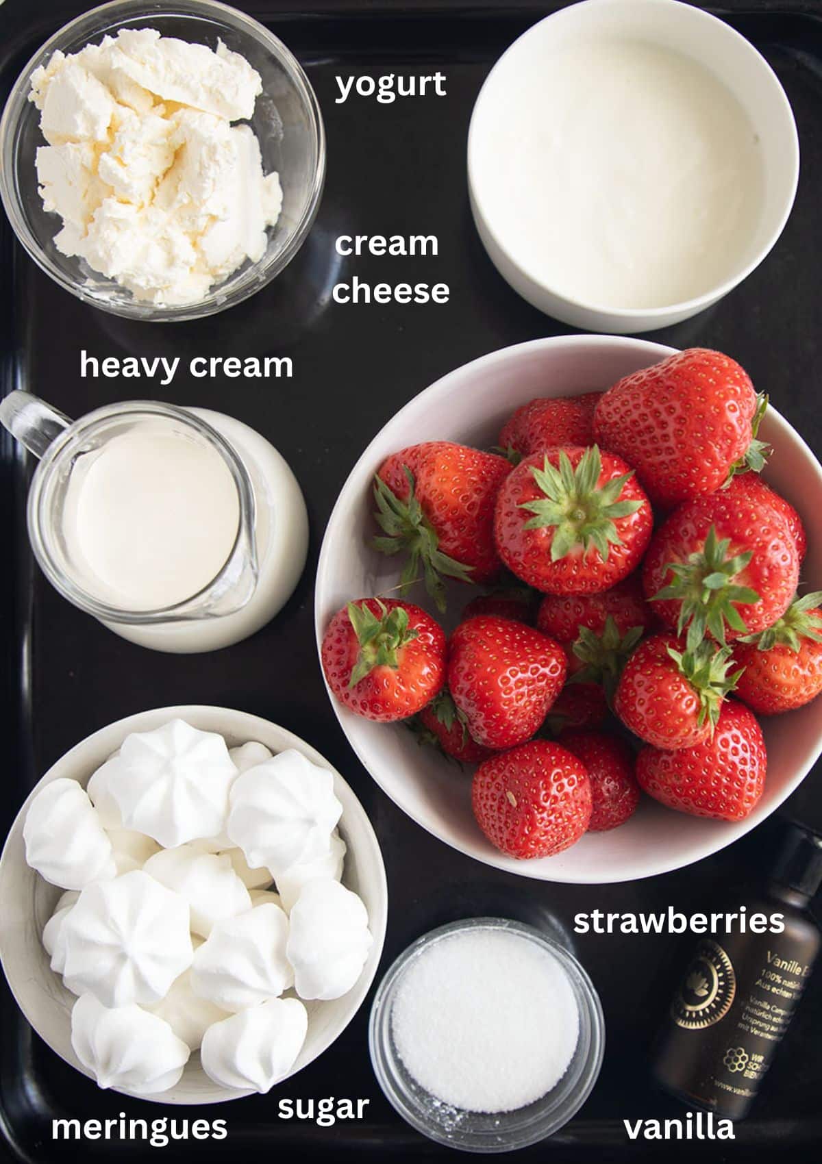 labeled ingredients for making dessert cups with strawberries, cream, yogurt, cream cheese and meringue.