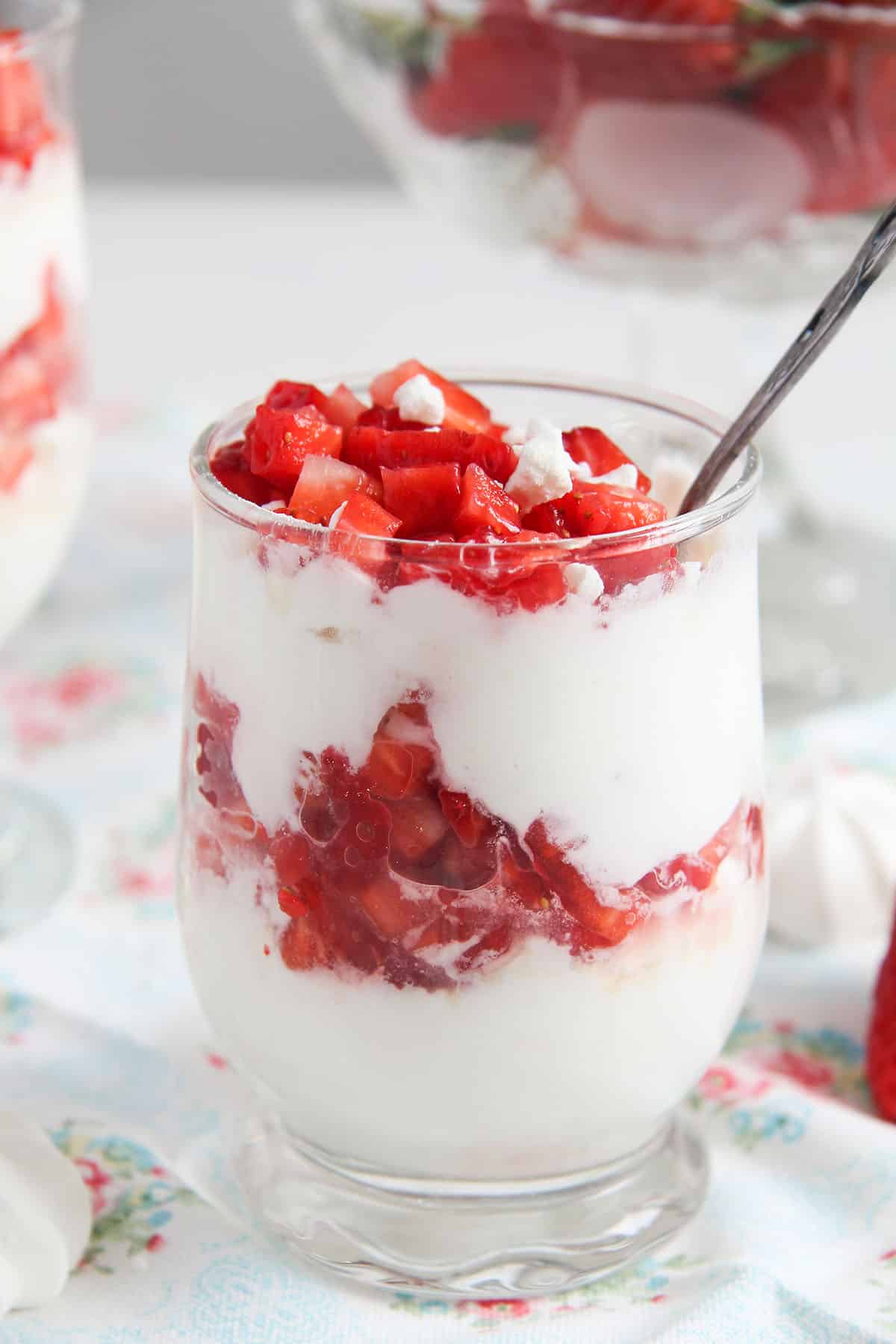 strawberry meringue dessert in a nice serving cup with a spoon in it.
