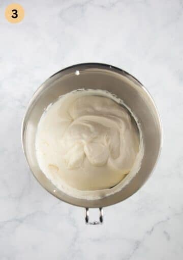 cream cheese, cream and yogurt mixture for making strawberry cups with meringue in a bowl.