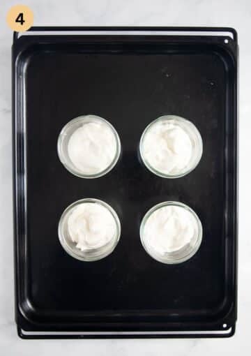 four cups with cream cheese mixture for making strawberry dessert.