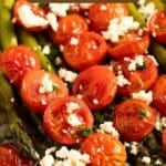 pinterest image with the title roasted asparagus and tomatoes.