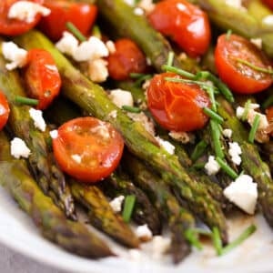 roasted asparagus and tomatoes with feta close up.