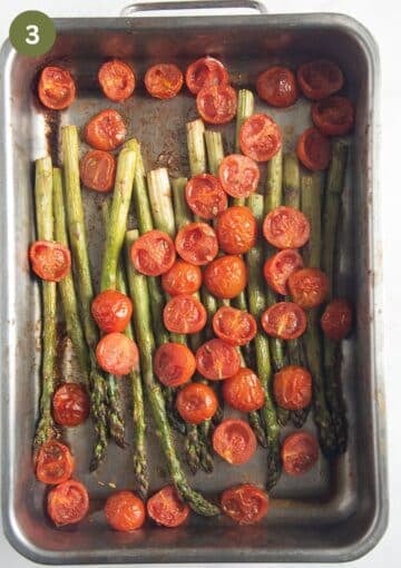roasting pan full with asparagus and cherry tomatoes after baking.
