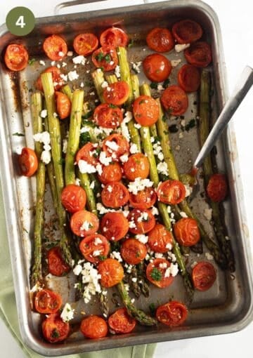 roasted tomatoes and asparagus in a baking dish with a spoon in it.