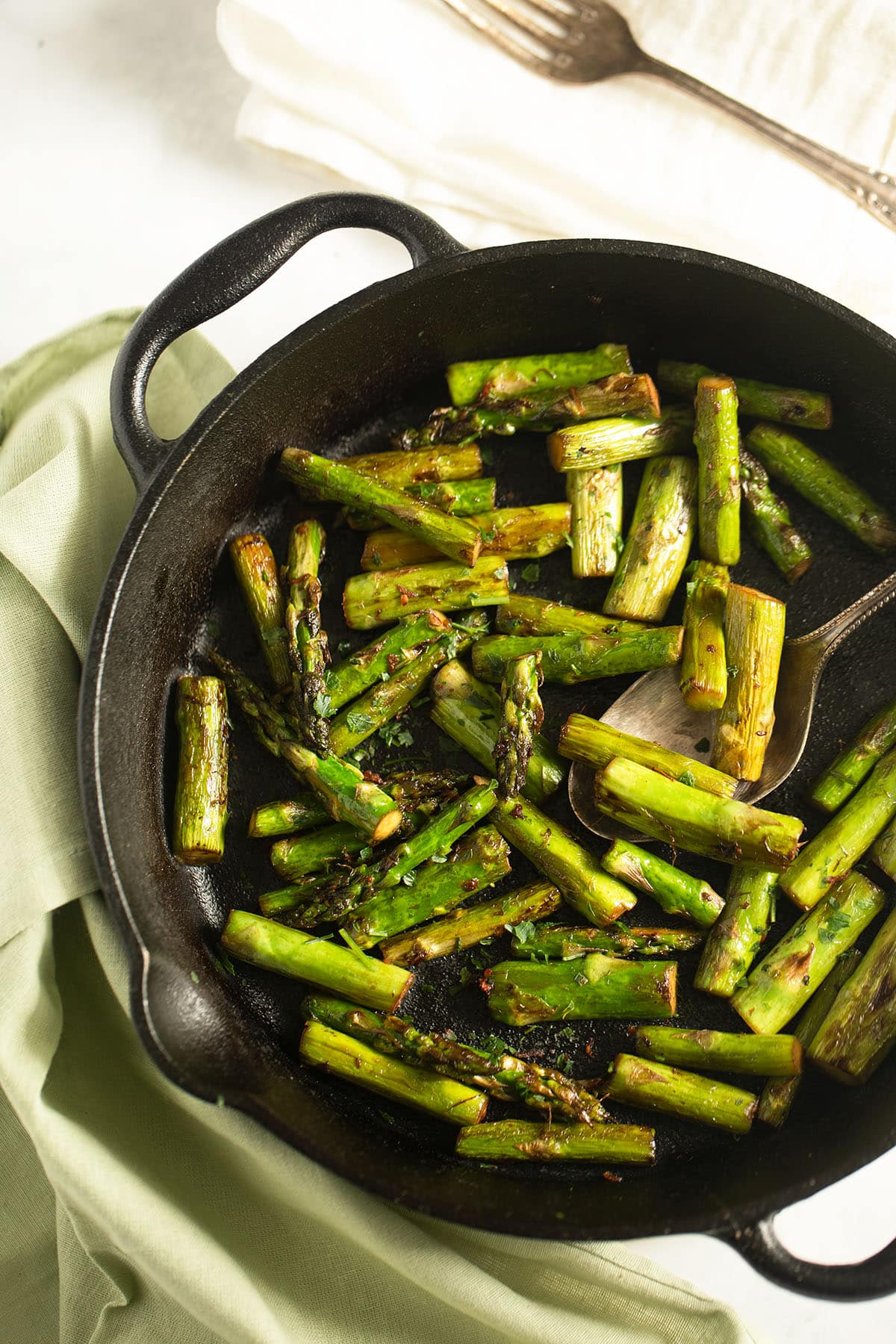 sauteed asparagus with garli, ginger and soy sauce in a cast iron skillet.