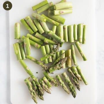 chopped green asparagus on a cutting board.