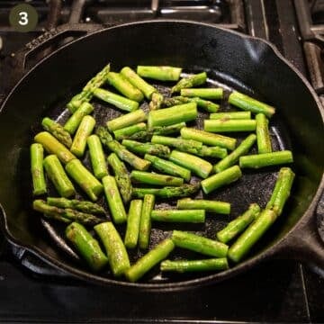 sauteing asparagus pieces in a large pan.
