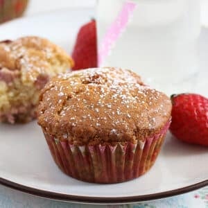 white chocolate strawberrry muffins on a plate.