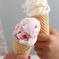 children hands holding cones of ice cream