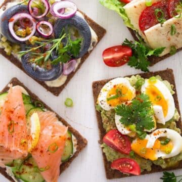 danish open faced sandwiches or smorrebrod with eggs, herring, salmon and cheese.