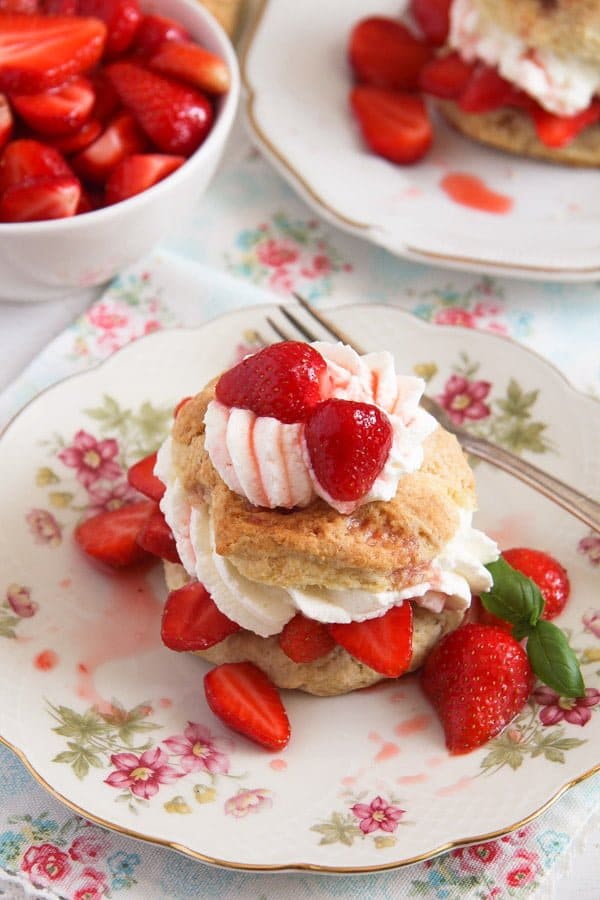 biscuits filled with cream and strawberries on a vintage plate