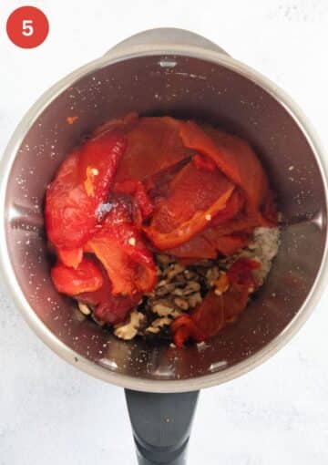 roasted red pepper pieces and other ingredients for making muhammara in a food processor.