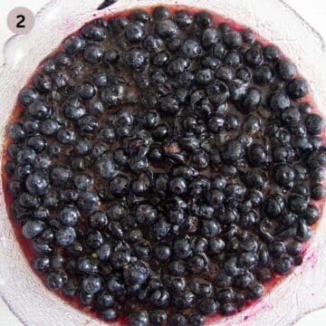 blueberries mixed with sugar for making sauce in a large bowl.