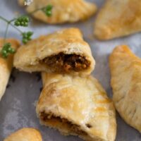 spicy beef empanadas cut in the middle and showing the filling