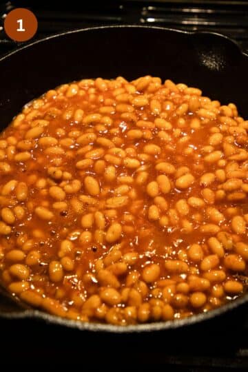 baked beans cooking in a large pot.