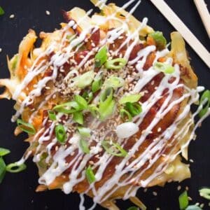 japanese cabbage pancake drizzled with okonomiyaki sauce.