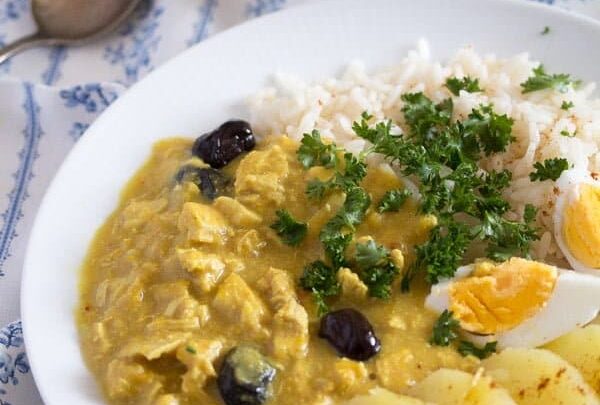 peruvian aji de gallina served with eggs and potatoes on a white plate