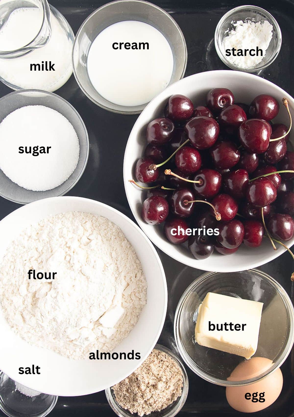 labeled ingredients for making swiss pie with fresh sweet cherries.