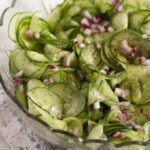 pinterest image with title of a bowl with cucumber salad with oil and vinegar.