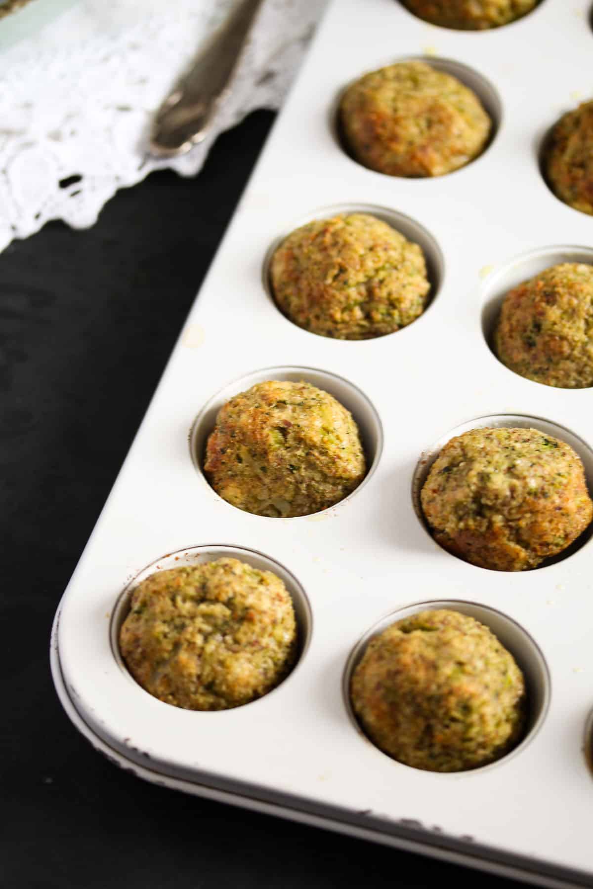 baked broccoli cauliflower bites in a mini muffin tin.