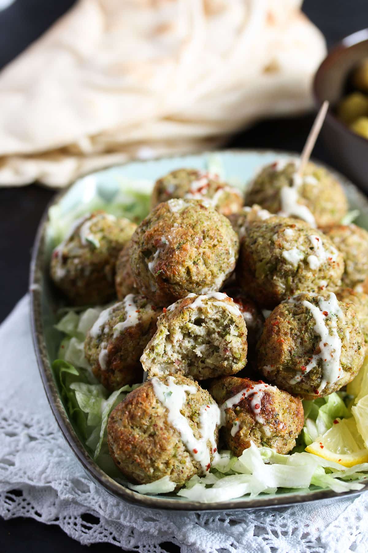 baked broccoli cauliflower bites on a bed of salad.