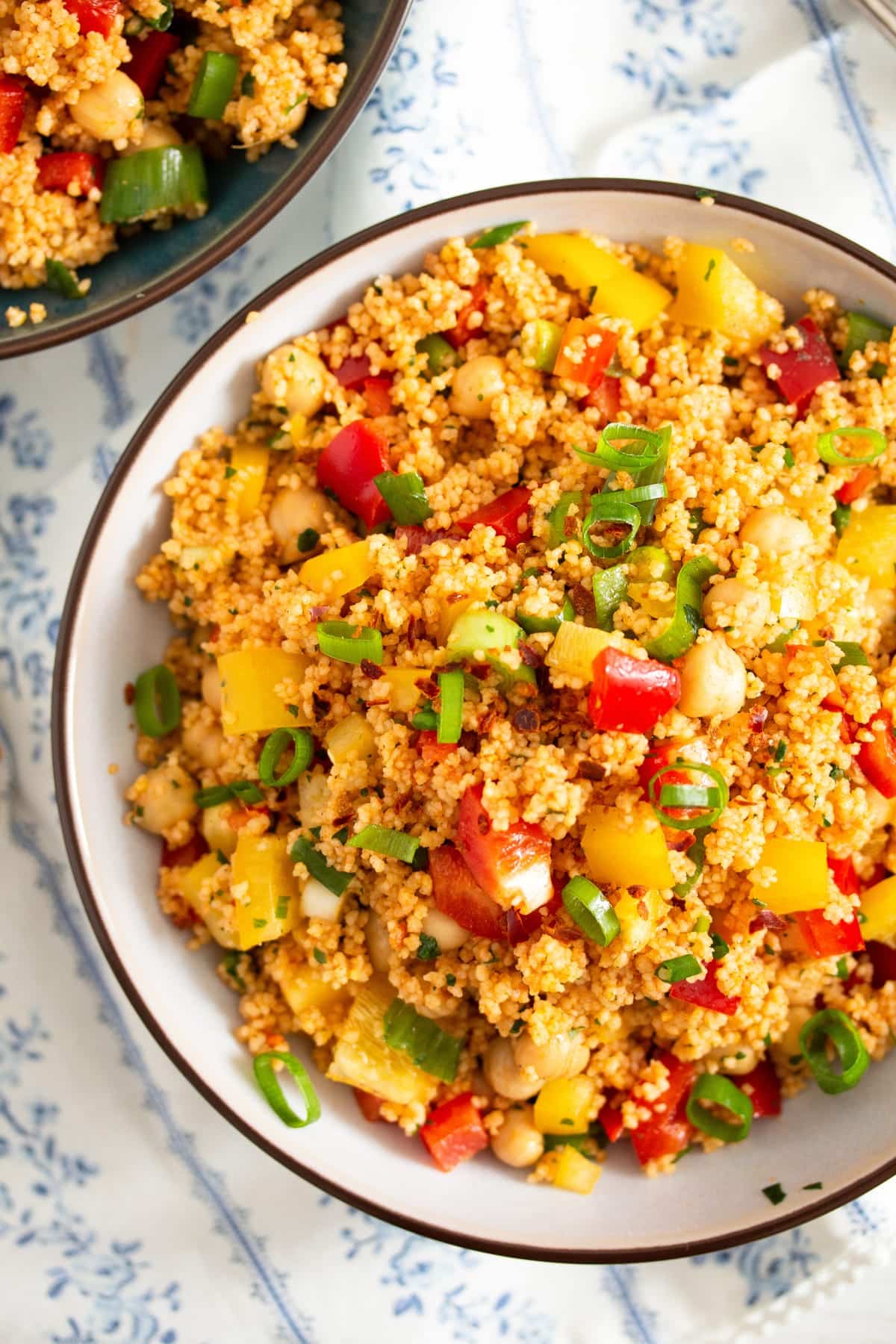 close up with curry couscous salad with green onions and bell peppers.