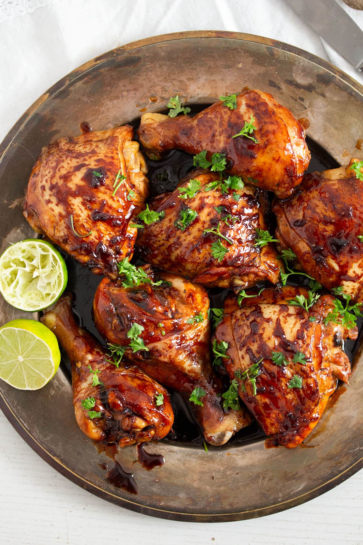 chicken with honey lime glaze and sprinkled with parsley on a platter.