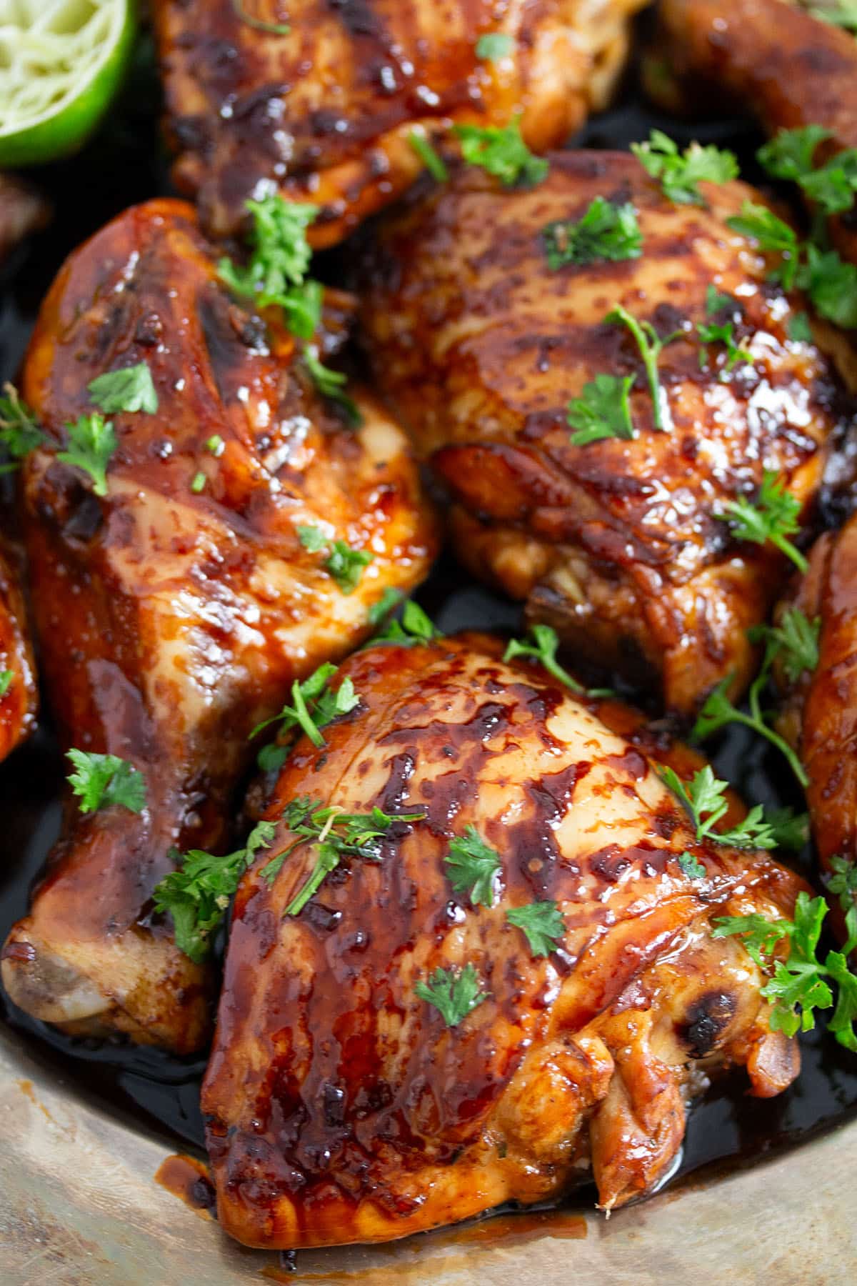 marinated chicken thighs with honey, lime, and soy sauce sprinkled with parsley.
