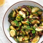 pinterest image with title for sauteed zucchini and onions recipe.