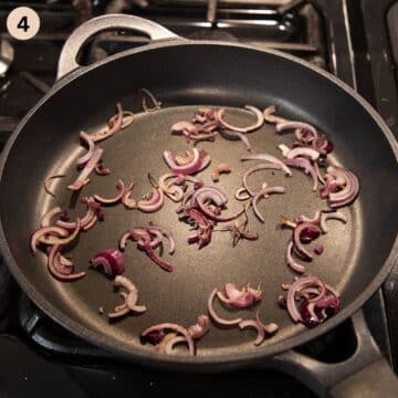 frying sliced red onions in a large pan.