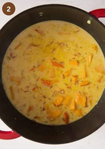 cooking pasta sauce with pumpkin pieces in a large pot.