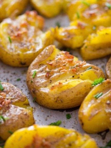 vegan smashed potatoes with garlic on a baking tray