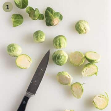 cleaning and cutting brussels sprouts on a cutting board with a small knife.