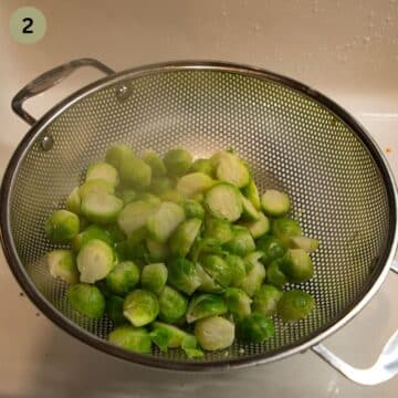 draining cooked brussels sprouts in a sieve.