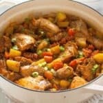 dutch oven full of korean chicken stew sprinkled with scallions.
