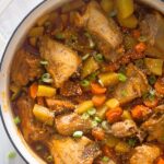 pot with chicken pieces, potatoes and carrots