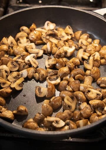 sauteed mushrooms in a cast iron skillet.