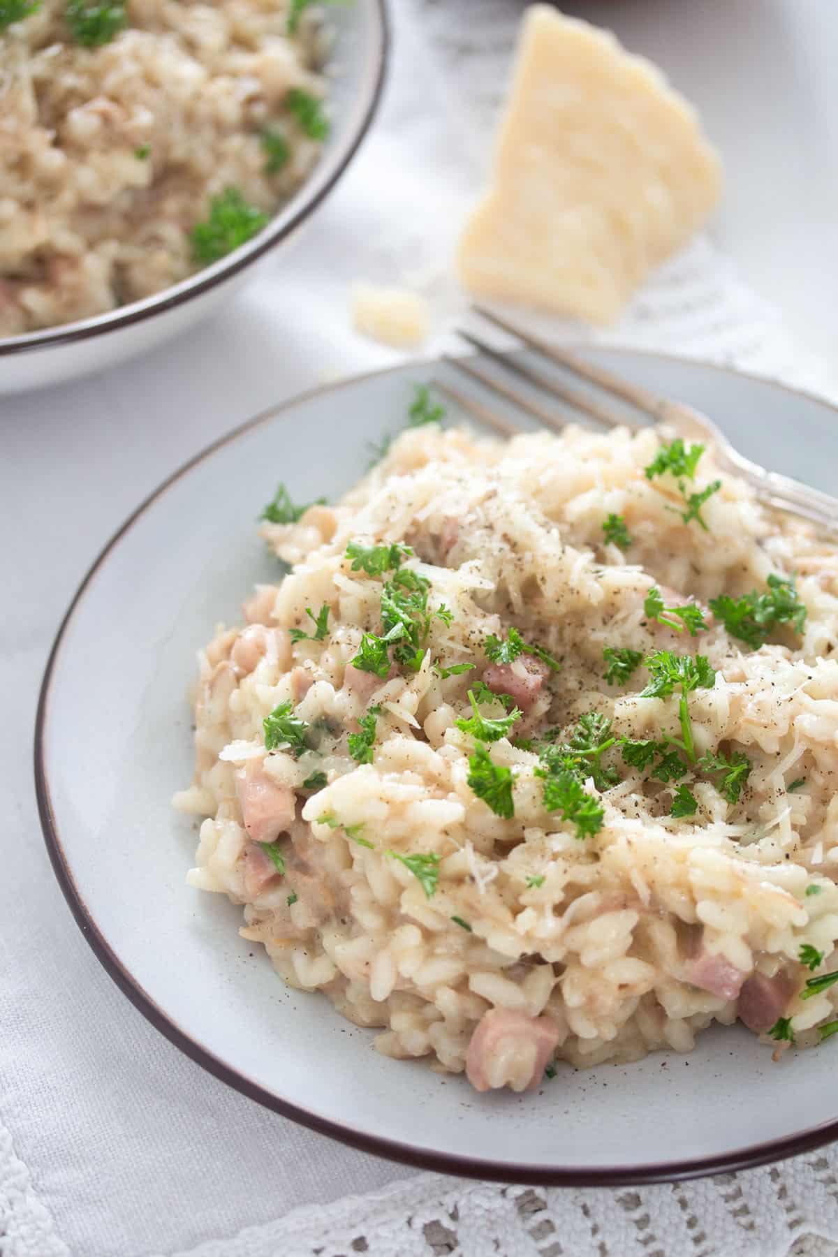 plate with leftover turkey risotto and a wedge of parmesan cheese.