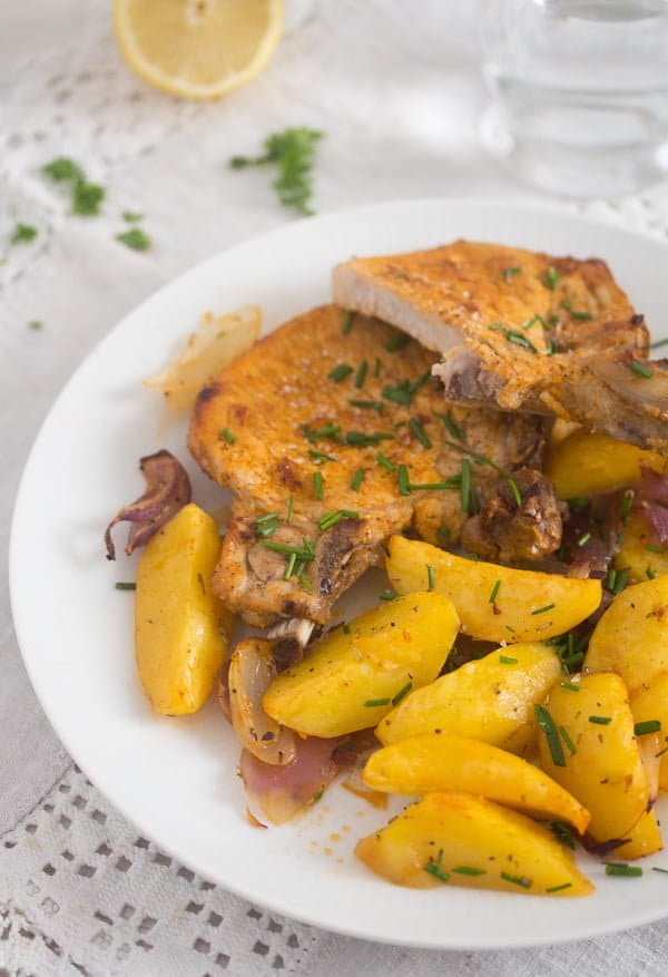 plate with baked pork chops and potatoes