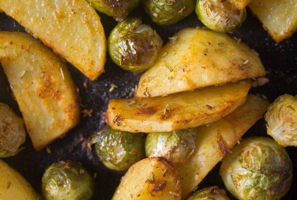tender potato slices and brussels sprouts close up